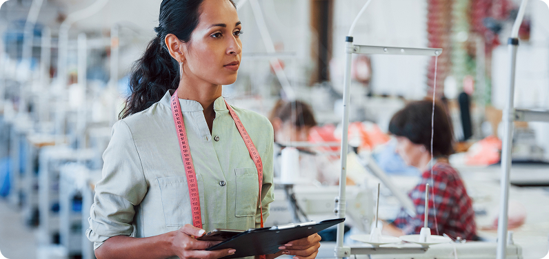 brunette dressmaker works factory holds notepad hands